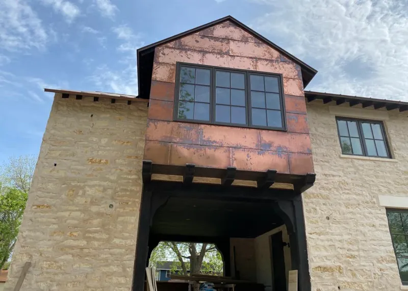 Copper metal panel facade on a stone building for Skylight Installation in Longmont